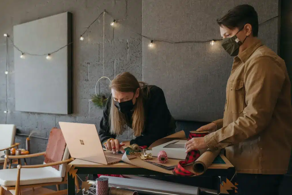 Two men managing sales on a Microsoft Surface
